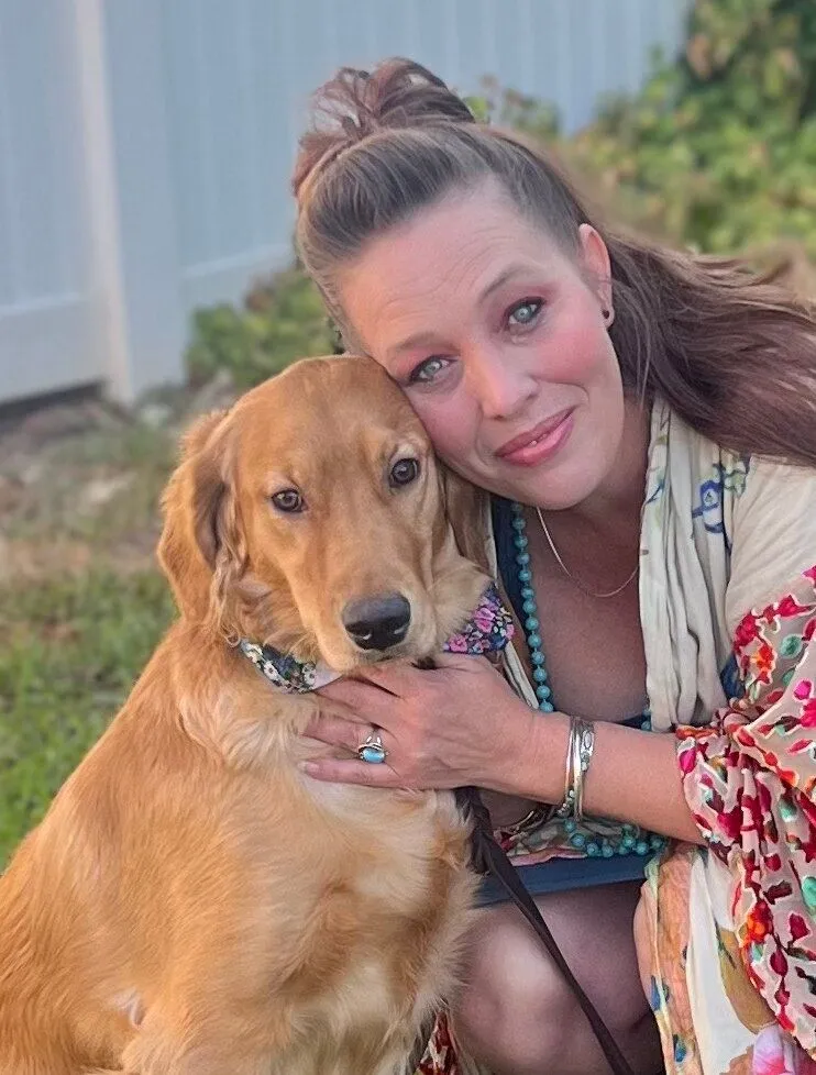 Julie hugging a dog